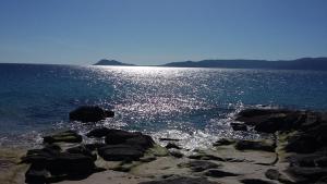 a large body of water with rocks in the water at Portosín -Suites in Portosin