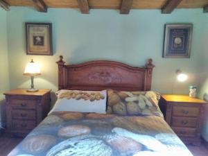 a bedroom with a large bed with rocks on it at la casuca del bosque in Liérganes