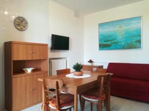 a living room with a wooden table and a couch at Villa Delux in Correzzola