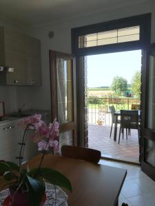 a kitchen with a sliding glass door to a patio at Villa Delux in Correzzola