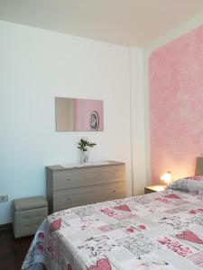 a bedroom with a bed and a dresser at Villa Delux in Correzzola +40 photos
