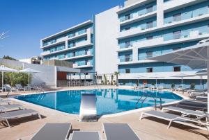 a swimming pool in front of a building at Blue Lagoon City Hotel in Kos Town