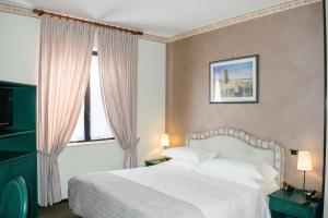 Postel nebo postele na pokoji v ubytování Villa San Carlo