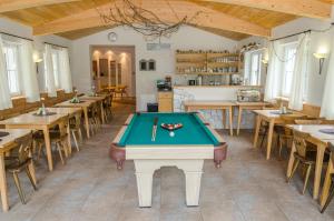 a pool table in a room with tables and chairs at Haus Julia in Spiss