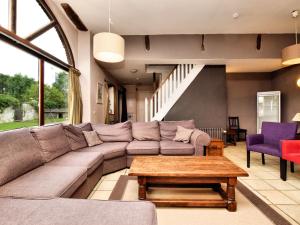a living room with a couch and a coffee table at Spacious holiday home in Lierneux with garden in Lierneux