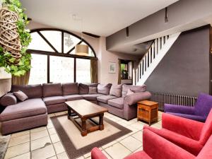 a living room with a couch and chairs at Spacious holiday home in Lierneux with garden in Lierneux