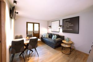 a living room with a couch and a table at Pension Baldauf - Dorf 31 in Kleinarl