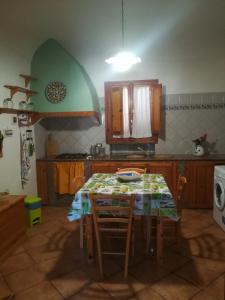 una cucina con tavolo e sedie di Le Case Di Tufo Riccio di mare a Favignana