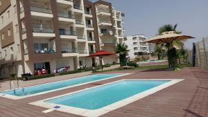 una piscina frente a un edificio de apartamentos en appart luxueux pieds dans l'eau en Port El Kantaoui