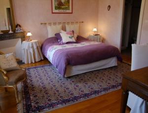 - une chambre avec un lit violet et 2 tables dans l'établissement Domaine de Gondrange - Chambres d'Hôtes, à Havange