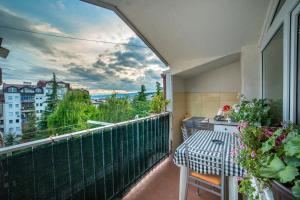 balcón con mesa y vistas a la ciudad en Apartments Magnolija, en Ohrid