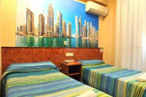 מיטה או מיטות בחדר ב-Hostal Venecia