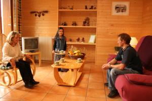 a group of people sitting in a living room at La Moraine in Villard-de-Lans