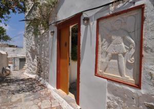 a painting of a man on the side of a building at Rallou House Hydra in Hydra