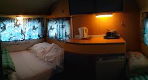 a small room with a small bed and a desk at Na kemping! in Pobierowo