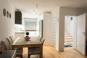 a kitchen and dining room with a table and chairs at Vacation home in Sarajevo