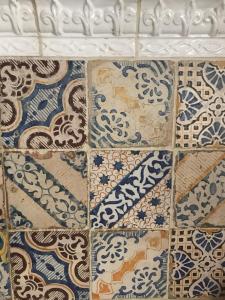 a tiled wall with a bunch of different colored tiles at Camidù Boutique House in Palermo +40 photos