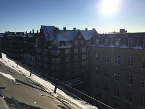 a group of buildings with snow on the roofs at Central & Cosy Studio + Free Bikes & Netflix in Copenhagen