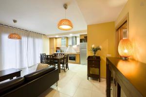 a living room and kitchen with a couch and a table at Apartaments Ca La Pauleta in Espluga de Francolí