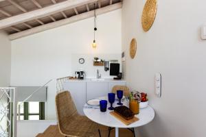 a small kitchen with a table and chairs in a room at Neratze Hammam Suites in Rethymno Town