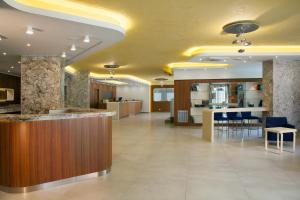 an office lobby with a bar and a kitchen at Hotel Aria in Rimini