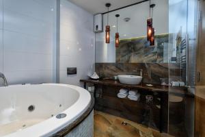a bathroom with a large tub and a sink at One Luxury Suites in Belgrade