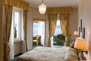 a bedroom with a bed and a large window at Hotel Milan Speranza Au Lac in Stresa +70 photos