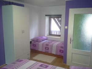 a bedroom with two twin beds and a window at K21 Apartment in Bovec