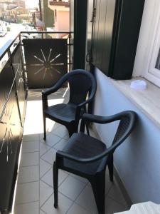 a couple of chairs sitting on a balcony at Casa Mara in Chioggia