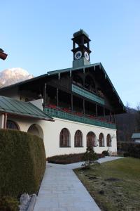 a building with a clock tower on top of it at Ferienwohnung Schwaiger am Königssee in Schönau am Königssee +6 photos
