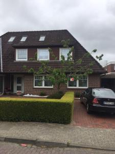 a house with a car parked in front of it at Haus Steffens in Esens