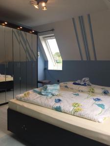 a large bed in a room with a window at Haus Steffens in Esens