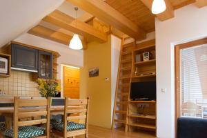 a kitchen and dining room with a table and a television at Alpine Spot in Kranjska Gora