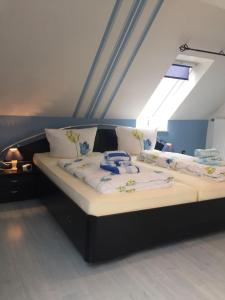 a large bed in a room with a window at Haus Steffens in Esens