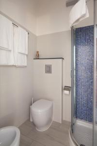 a white bathroom with a toilet and a shower at Sciuscettùa 5 Terre in Monterosso al Mare