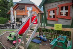 a playground with a slide in front of a house at Alpine Spot in Kranjska Gora