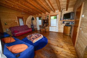 a living room with a blue couch and a table at BioAgriturismo Vegan Campo di Cielo in Cesiomaggiore