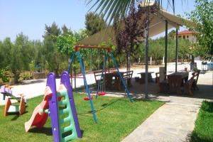 a park with a playground with a slide at Fantasia Studios and Apartments in Neos Marmaras