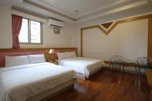Letto o letti in una camera di Long Shan Hotel