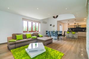 a living room with a couch and a table at Milohanic Luxury Apartments in Poreč