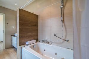a bathroom with a tub and a shower at Milohanic Luxury Apartments in Poreč +37 photos