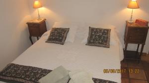 a large white bed with two pillows on it at Les Hauts des Materonnes in Tourves