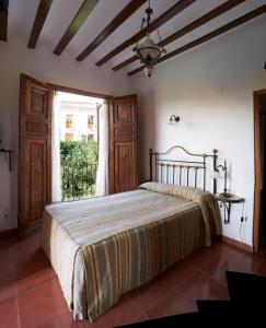 Ένα ή περισσότερα κρεβάτια σε δωμάτιο στο Hotel Casa de los Arcos