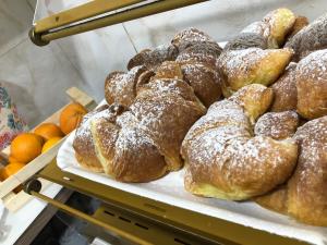 a bunch of pastries on display in a bakery at New Royal in Agerola