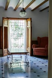 a living room filled with furniture and a window at Hotel Casa de los Arcos in Vélez Blanco