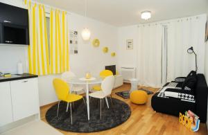 a kitchen and a living room with a table and chairs at Golden Gate Apartment Zadar in Zadar