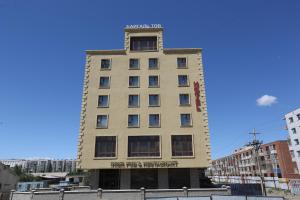 a tall building with a clock on top of it at Baigal Hotel in Ulaanbaatar