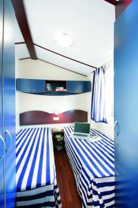 Ein Bett oder Betten in einem Zimmer der Unterkunft New Camping Le Tamerici