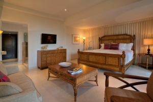 a bedroom with a bed and a living room at Quinta Elvira in Cuernavaca