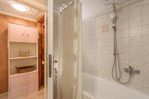 a bathroom with a shower and a tub at Evridiki's House Apartment and Studio in Pitsidia